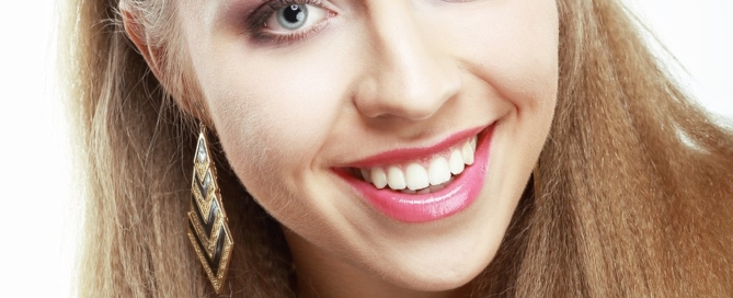 Young woman smiling and showing straight white teeth