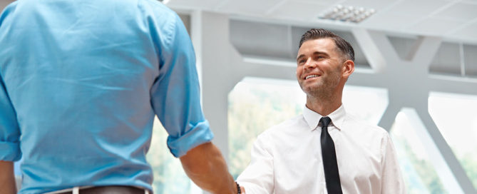 orthodontist greeting male invisalign patient